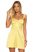 Woman wearing a bright yellow satin mini dress with lace straps and a sweetheart neckline a fun look for a Summer cocktail party or Homecoming