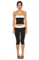Black strapless top with white polka dot bands at the bust and cropped hemline