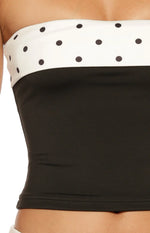 Black strapless top featuring a white band with black polka dots at the bust, cropped and fitted