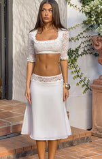 White A-line midi skirt with a wide sheer lace trim detail at the waist