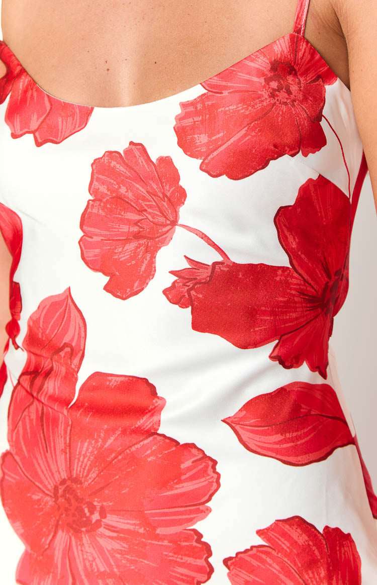 Close-up of the white maxi dress with large red anemone floral print and thin spaghetti strap