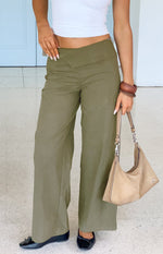 Green straight leg pants with a unique V-shaped crossover waistband and relaxed fit