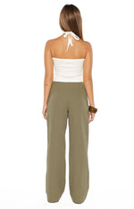 Rear view of the green straight leg pants showing the relaxed fit and smooth fabric from behind