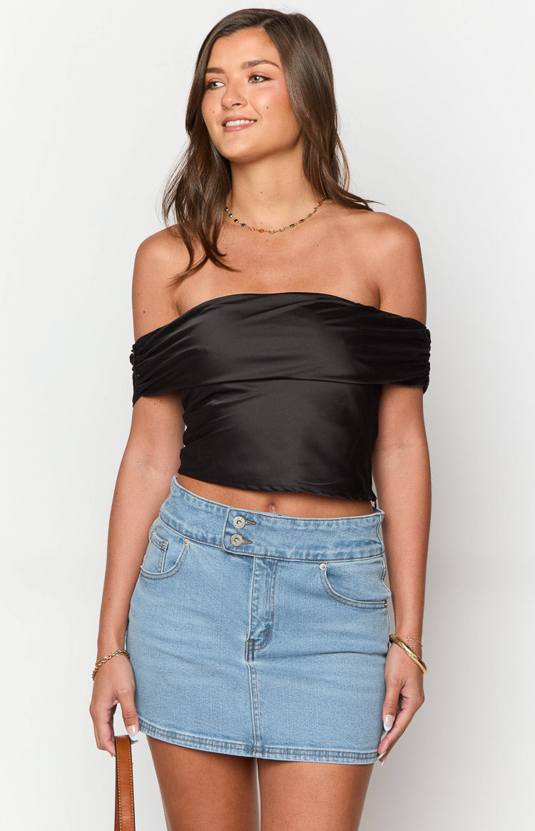 Light wash denim mini skirt with a double button waistband and curved front pockets