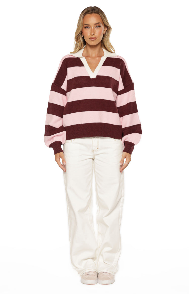 Front view of a relaxed fit pink and maroon striped knit polo with a white V-neck collar and long balloon sleeves