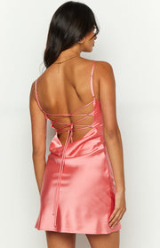 Rear view of the pink satin mini dress with a low cowl back and adjustable criss-cross tie straps