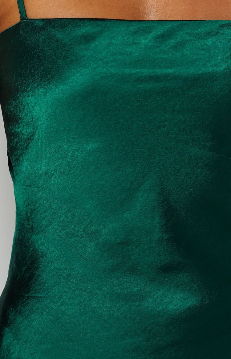 Emerald green satin mini dress with a draped cowl neckline and criss-cross lace-up back