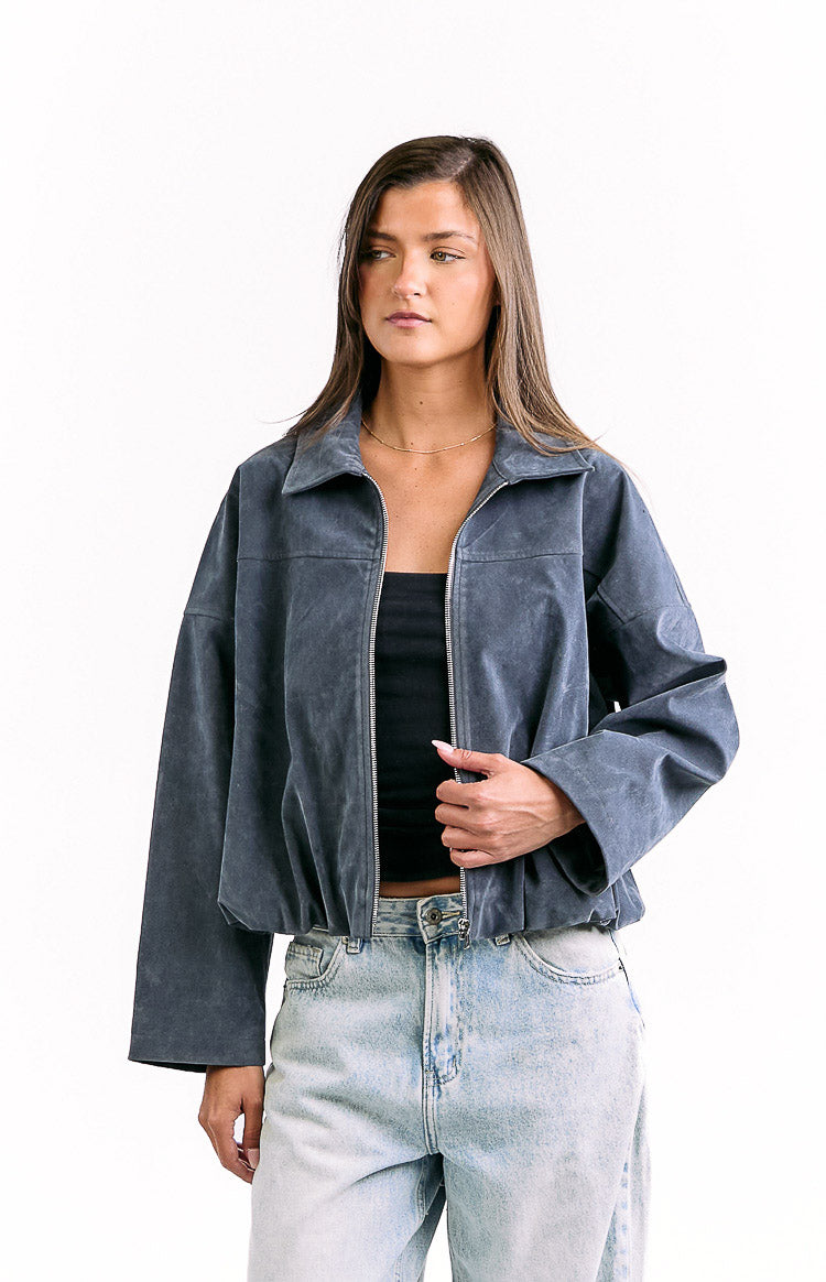 Angled front view of a steel grey suedette bomber jacket with a full zip front and bubble hem