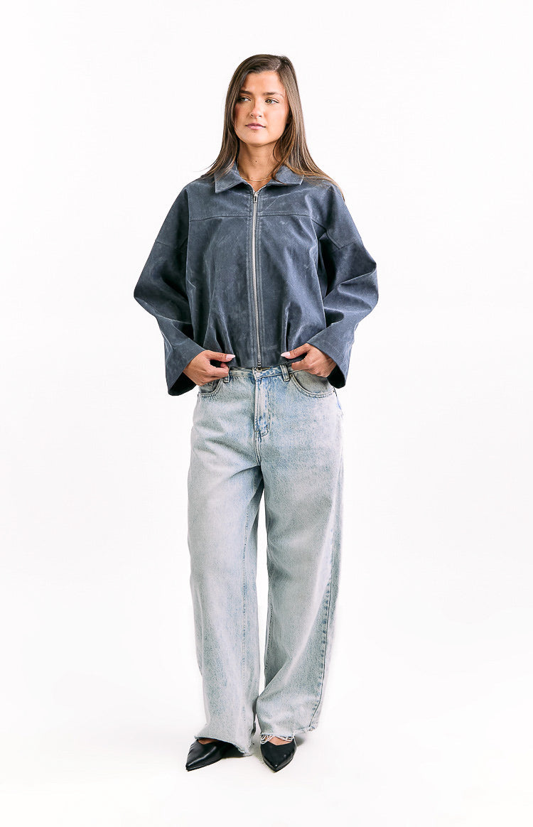Front view of a steel grey suedette bomber jacket with a full silver zipper, classic collar, wide sleeves, and gathered bubble hem