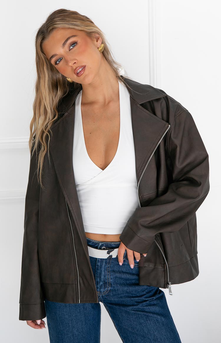 Front view of the oversized chocolate brown PU biker jacket, worn open to show wide lapels and textured material