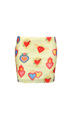 Flat lay of the yellow mesh mini skirt showcasing the full vibrant sacred heart print with flaming and winged motifs