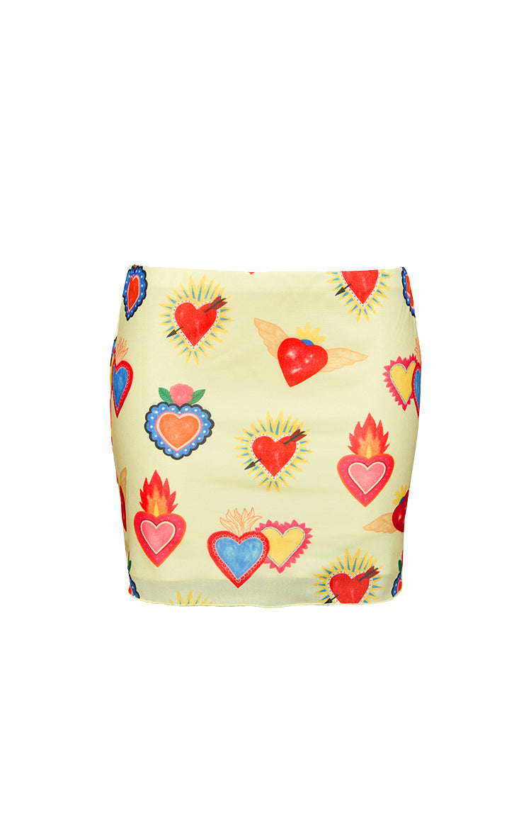 Flat lay of the yellow mesh mini skirt showcasing the full vibrant sacred heart print with flaming and winged motifs