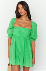 Green babydoll mini dress with a square neckline, textured check fabric, and short puff sleeves