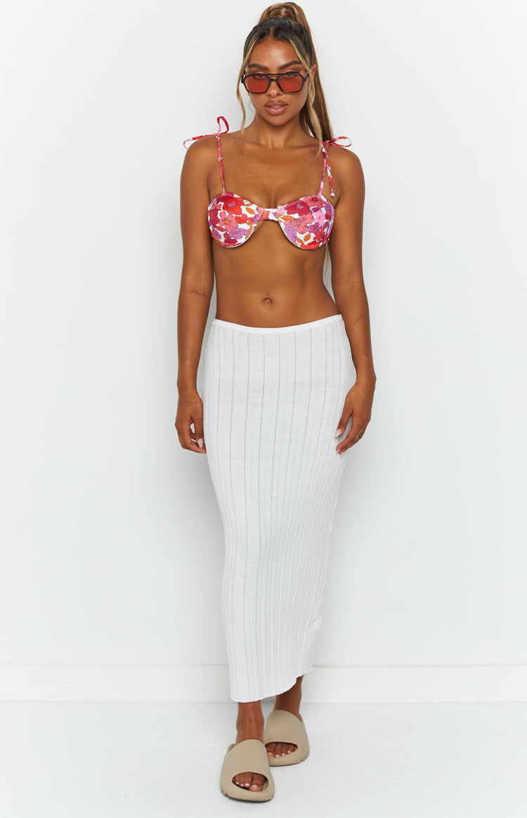 Close-up of the white ribbed knit fabric of the skirt, showing the fine vertical texture and waistband