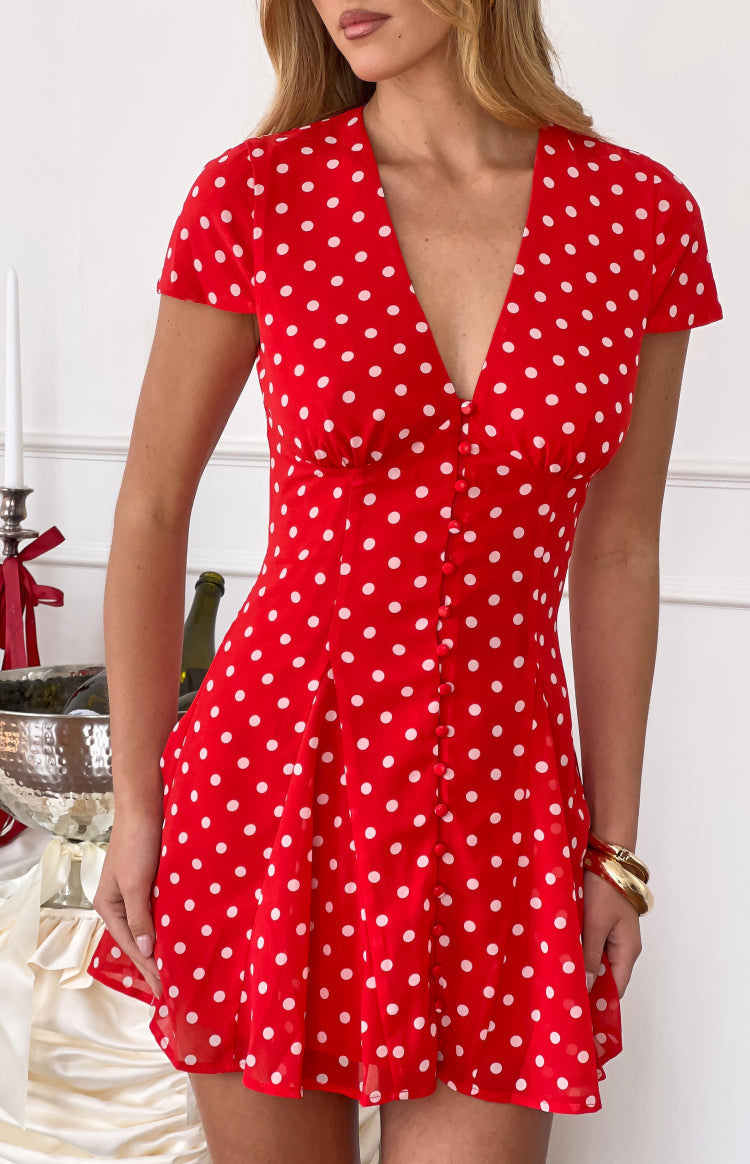 Red polka dot chiffon mini dress with a deep V-neck, short sleeves, button-front, and gathered waist