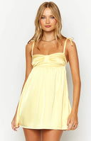 Beginning Boutique Sammie Yellow Satin Mini Dress yellow satin babydoll mini dress with ruched sweetheart neckline and tied s