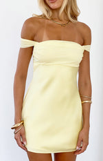 Close-up of the yellow off-shoulder mini dress with a ruched bust and smooth satin-like fabric