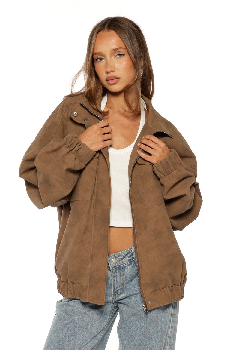 Front view of a brown oversized suedette jacket with an open zipper, funnel neck, and ruched elasticated cuffs