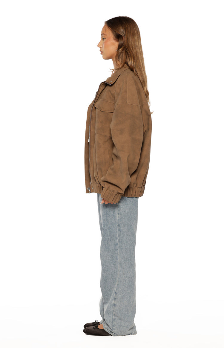 Side view of the brown oversized suedette jacket with a funnel neck, chest pockets, and elasticated hem and cuffs