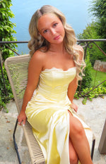 Yellow satin strapless maxi dress with white lace trim sweetheart neckline, boned bodice, ruched side, and high leg slit