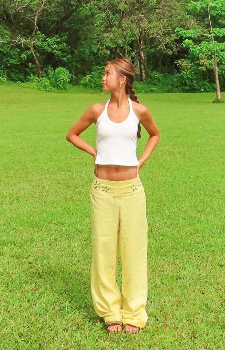 Front view of a white halter neck top with a scoop neckline and cropped hem