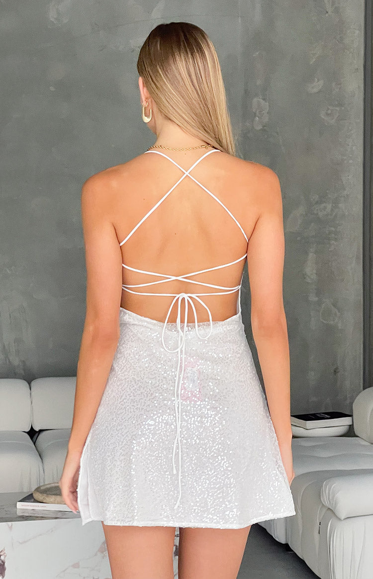 Rear view of a white beaded mini dress with criss-cross tie-back straps and a low back