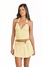 Yellow A-line mini skirt with a wrap-around waist and a gold-toned ring detail