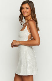 Side view of a white beaded mini dress with square neckline and side cutouts with criss-cross lacing
