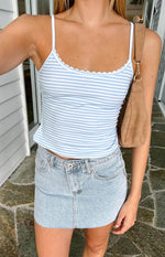 Close-up of the blue and white striped singlet with white scalloped lace trim along the neckline and thin spaghetti straps