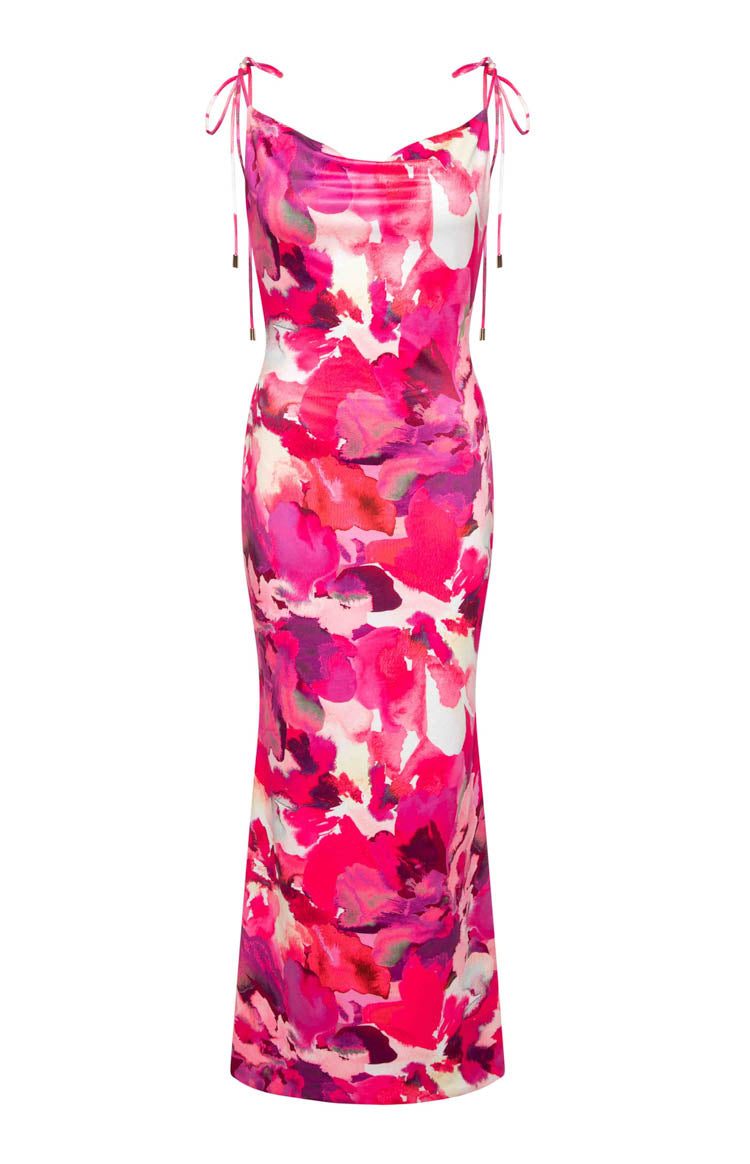 Side view of a pink floral print maxi dress with a cowl neck, tie straps, and side waist cutouts