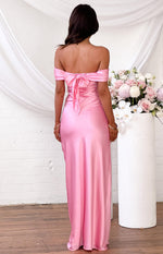Rear view of a pink satin off-the-shoulder maxi dress with a self-tie bow at the back