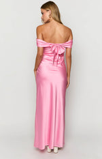 Rear view of a pink off-the-shoulder maxi dress with a large bow tie at the back and ruched sleeves