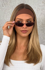 Close-up of the brown wide fabric headband with a smooth matte finish