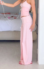 Side view of light pink jersey pants with a wide leg and a striped foldover waistband