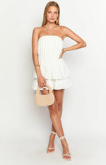 White strapless mini dress with a shirred waist and tiered ruffle skirt