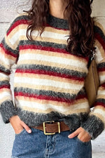 Close-up of the fluffy multi-stripe oversized sweater showing the textured knit and ribbed cuffs