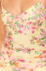Close-up of the yellow mesh maxi dress with pink and orange floral print and ruched detailing