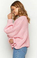 Sorbet pink chunky knit cardigan side view with oversized balloon sleeves and thick ribbed cuffs