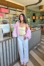 Sorbet pink chunky knit cardigan worn open, showing the relaxed fit and voluminous sleeves
