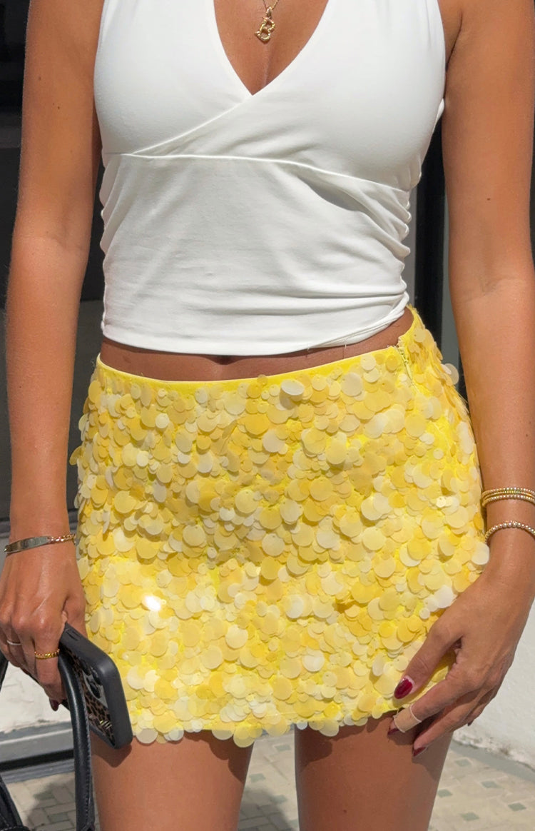 Close-up of a vibrant yellow paillette mini skirt a statement piece for a bachelorette party or festive event