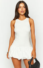Front view of a white mini dress with a ribbed knit tank-style top and a gathered bubble skirt