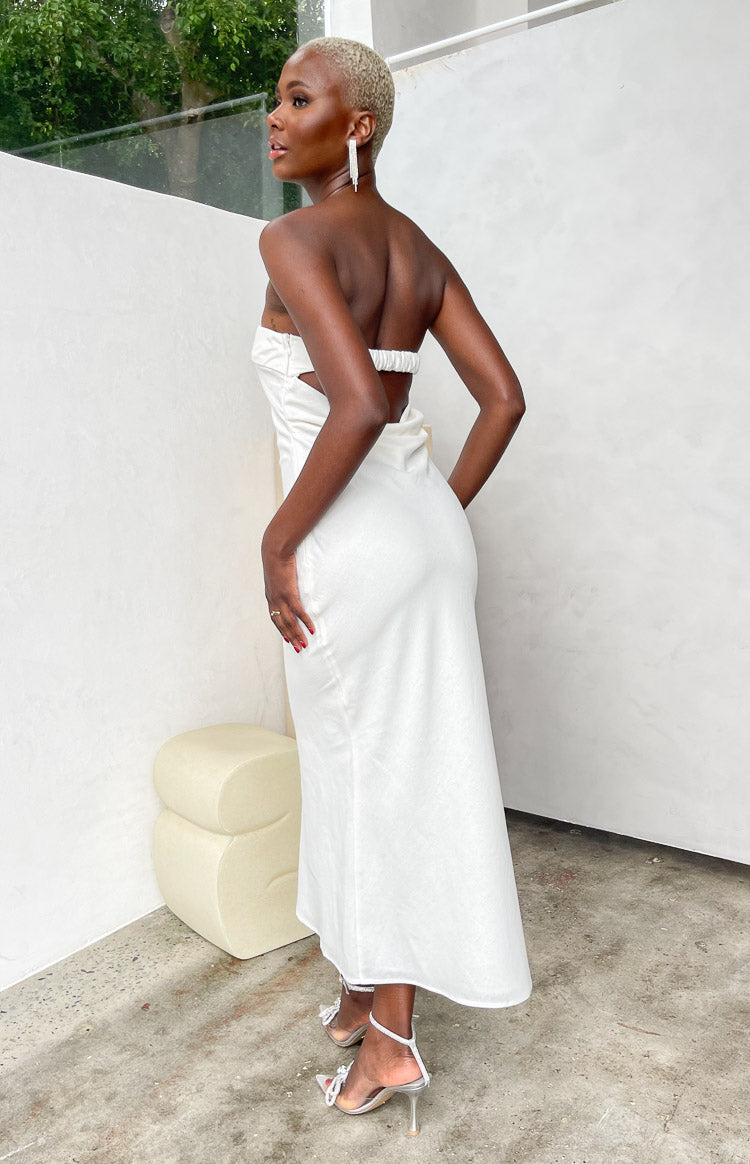 Rear view of a cream strapless midi dress with a back cutout and ruched elastic band