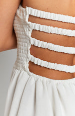White textured dress with shirred back panel and three horizontal strap cutouts