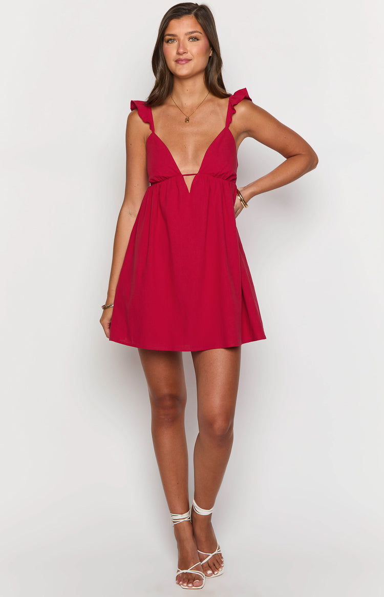 Front view of a red mini dress with a deep V-neckline, thin ruffled shoulder straps, and a flowy skirt