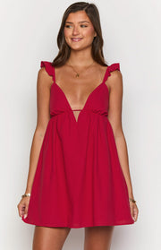 Deep V-neck red mini dress with a thin horizontal strap and ruffled shoulder straps
