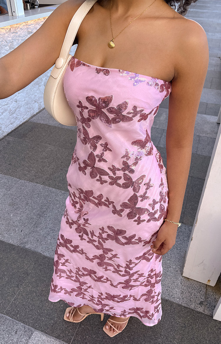 Rear-side view of a pink strapless maxi dress with all-over rose gold butterfly sequins