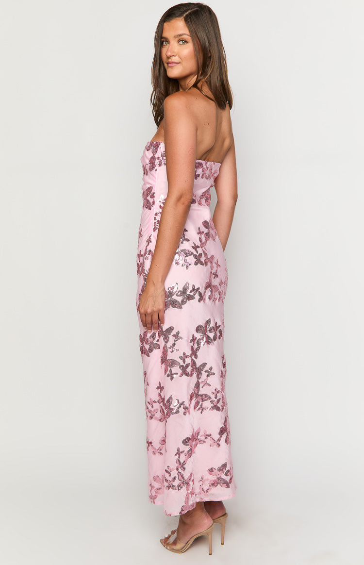 Side view of a pink strapless maxi dress with all-over sequin butterfly pattern