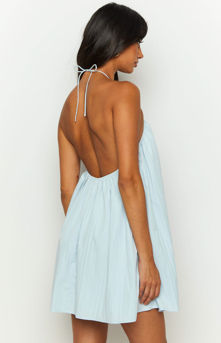 Rear view of a light blue textured mini dress with a tied halter neck and deep open back