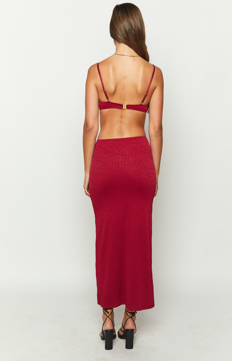 Back view of a red ribbed knit maxi dress with a bra-style top, thin spaghetti straps, and gold clasp