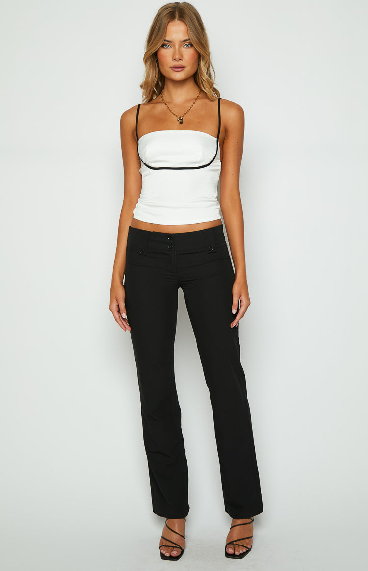 Fitted white top with a straight neckline, thin black spaghetti straps, and a black trim detail under the bust